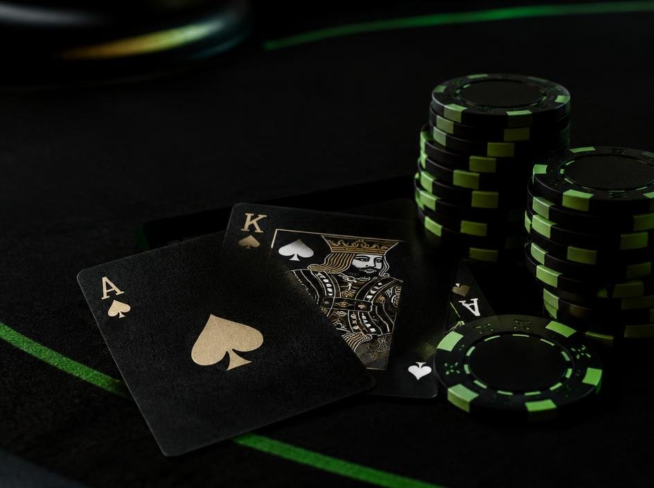 Blackjack cards and stacked chips on a dark table